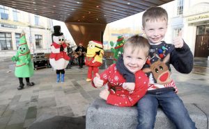 Two young boys get into the festive spirit with the Friendly Faces characters during the Christmas entertainment in Ballymena.