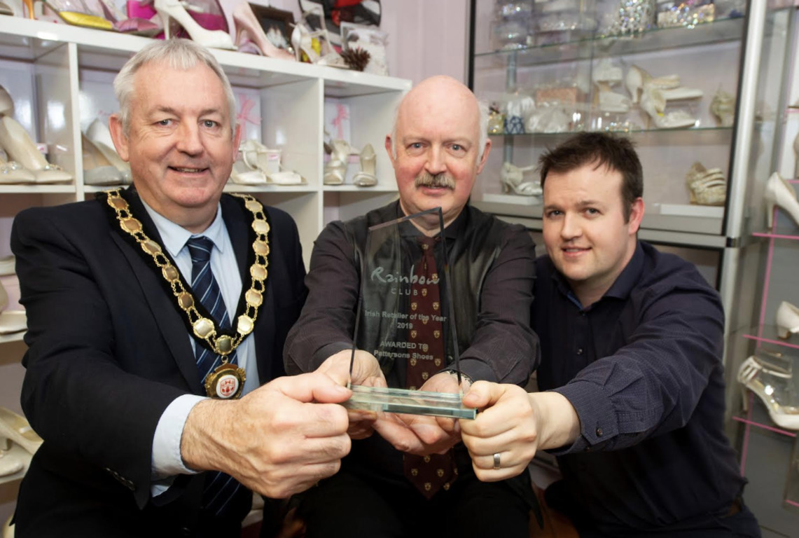 Chair of Mid Ulster District Council, Councillor Sean McPeake is pictured with Nigel and Scott Patterson from Pattersons Shoes Dungannon and their Rainbow Club Irish Retailer of the Year award.