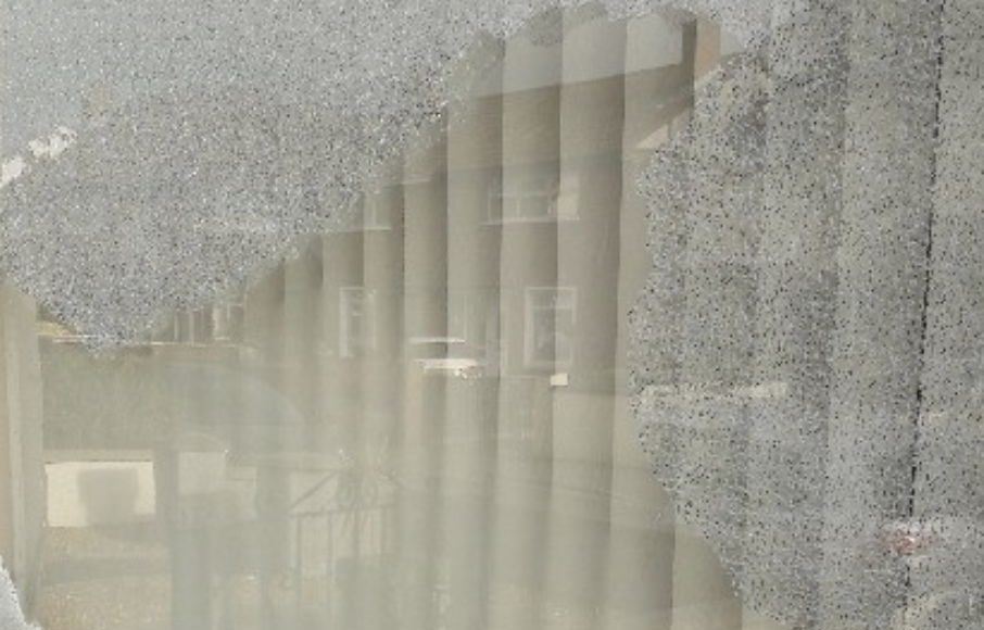 The broken window of the property at Carrickfergus,
